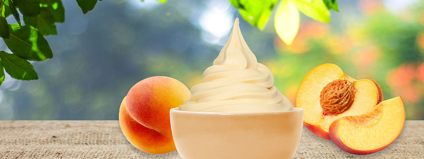 A cup of frozen yogurt alongside a sprig of mint and green top hat.