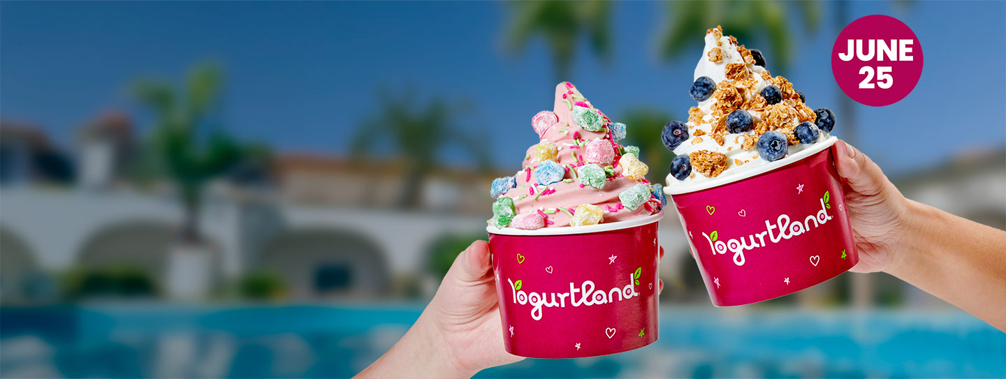 Hands holding two cups of Yogurtland frozen yogurt.