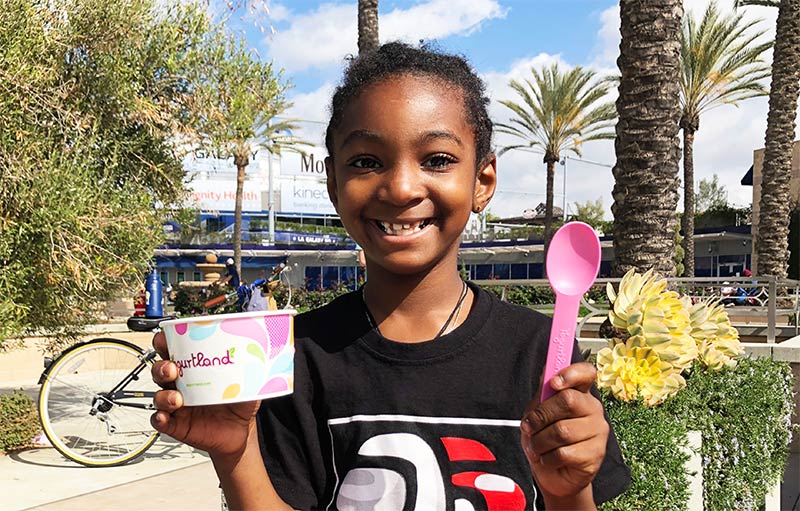 A child enjoying Yogurtland outside.