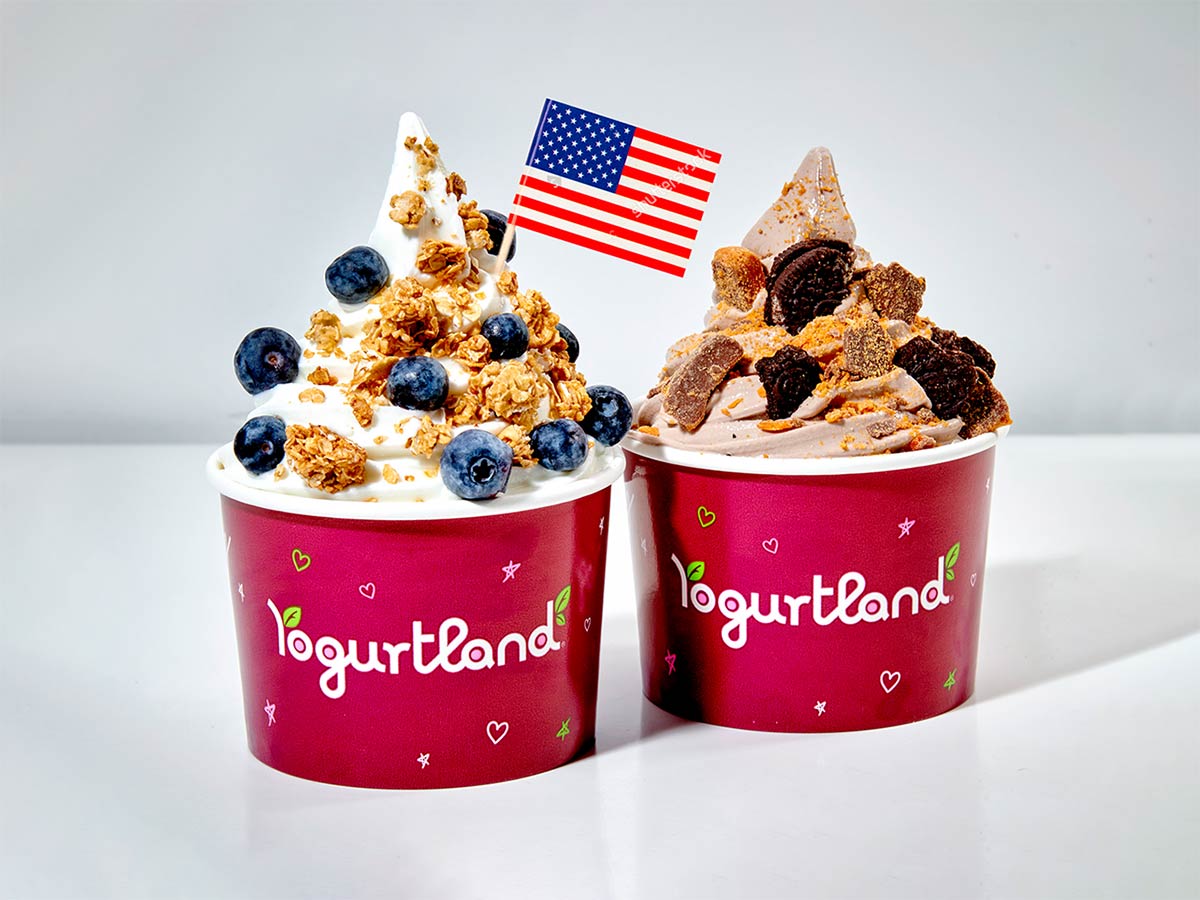 Two Yogurtland frozen yogurt cups with an American flag